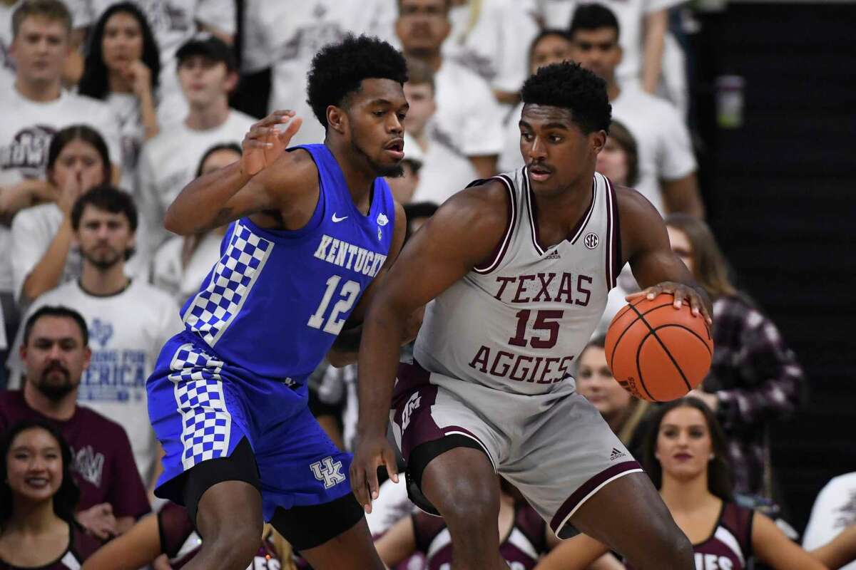 Texas A&M forward Henry Coleman III (15) is defended by Kentucky forward Keion Brooks Jr. (12) during the first half of an NCAA college basketball game Wednesday, Jan. 19, 2022, in College Station, Texas. (AP Photo/Justin Rex)