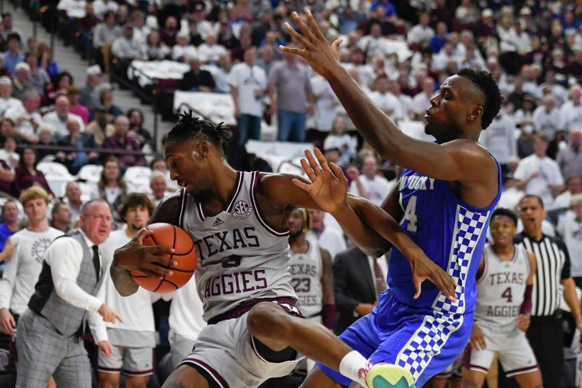 Kentucky forward Oscar Tshiebwe (34) fouls Texas A&M guard Quenton Jackson during the first half of an NCAA college basketball game Wednesday, Jan. 19, 2022, in College Station, Texas. (AP Photo/Justin Rex)