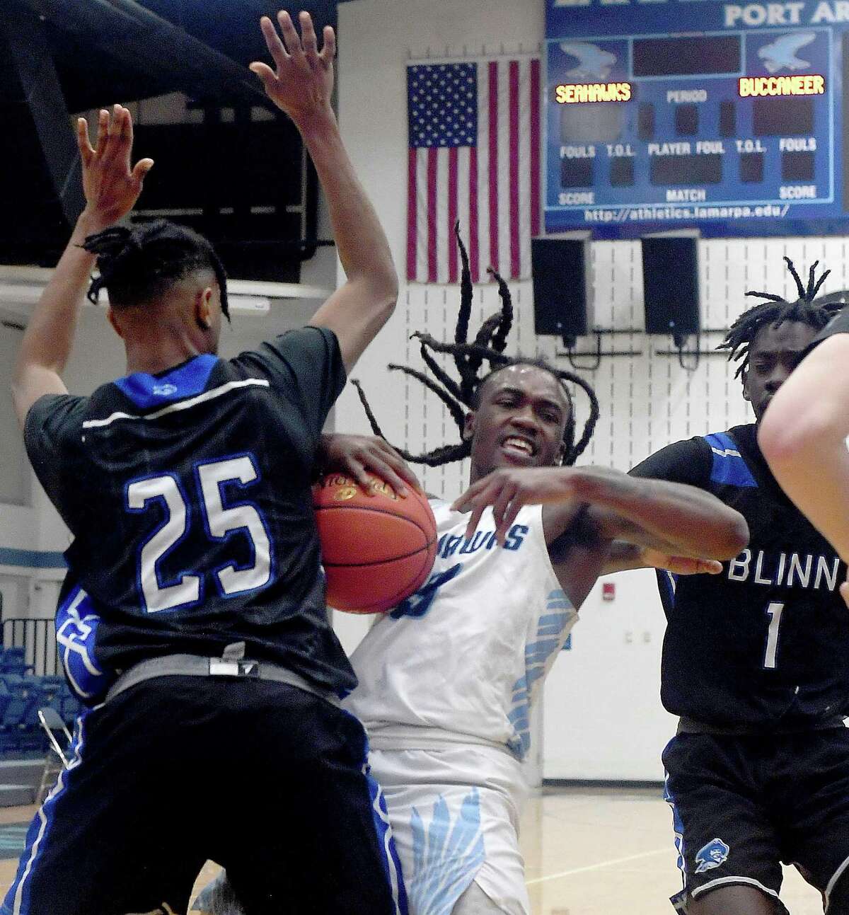 Lamar State College Port Arthur's Kanntrell Burney is double teamed by Blinn's Tyler Jackson (left) and Braelon Seals during their game Wednesday at LSCPA. Photo made Wednesday, January 19, 2022 Kim Brent/The Enterprise