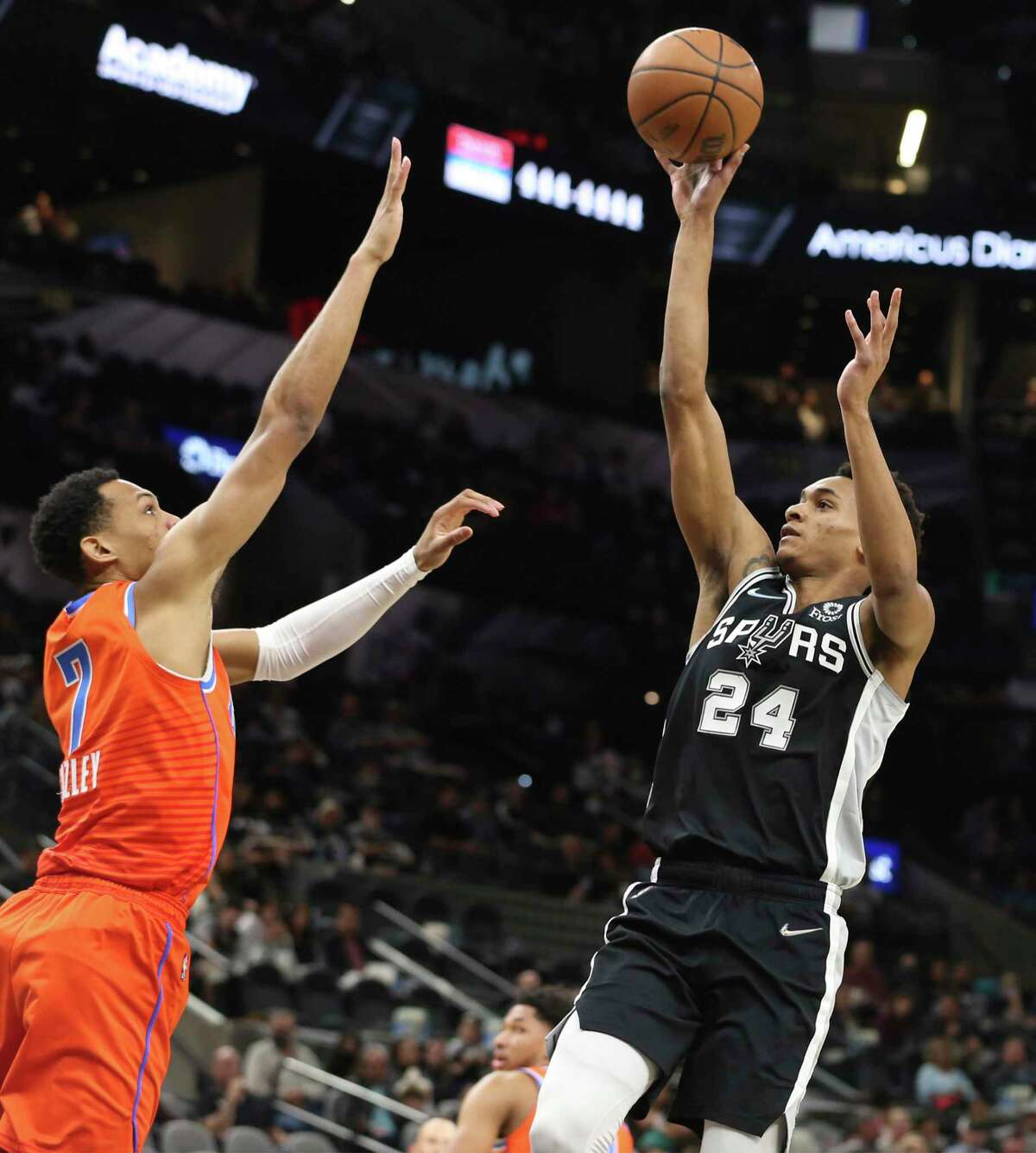 Spurs' Devin Vassell (24) shoots against Oklahoma City Thunders' Darius Bazley (07) during their game at the AT&T Center on Wednesday, Jan. 19, 2022.