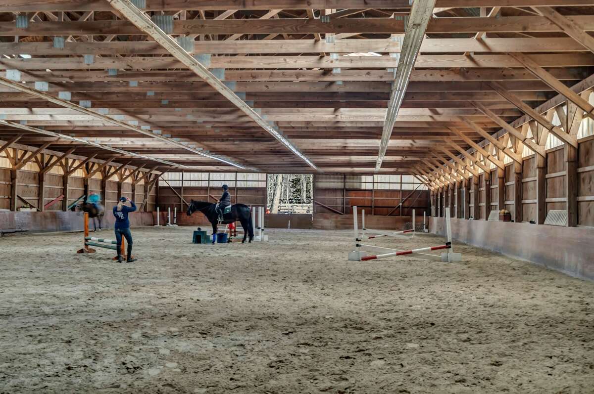The home on 2 Race Hill Road in Madison, Conn. has an indoor horse riding arena. 