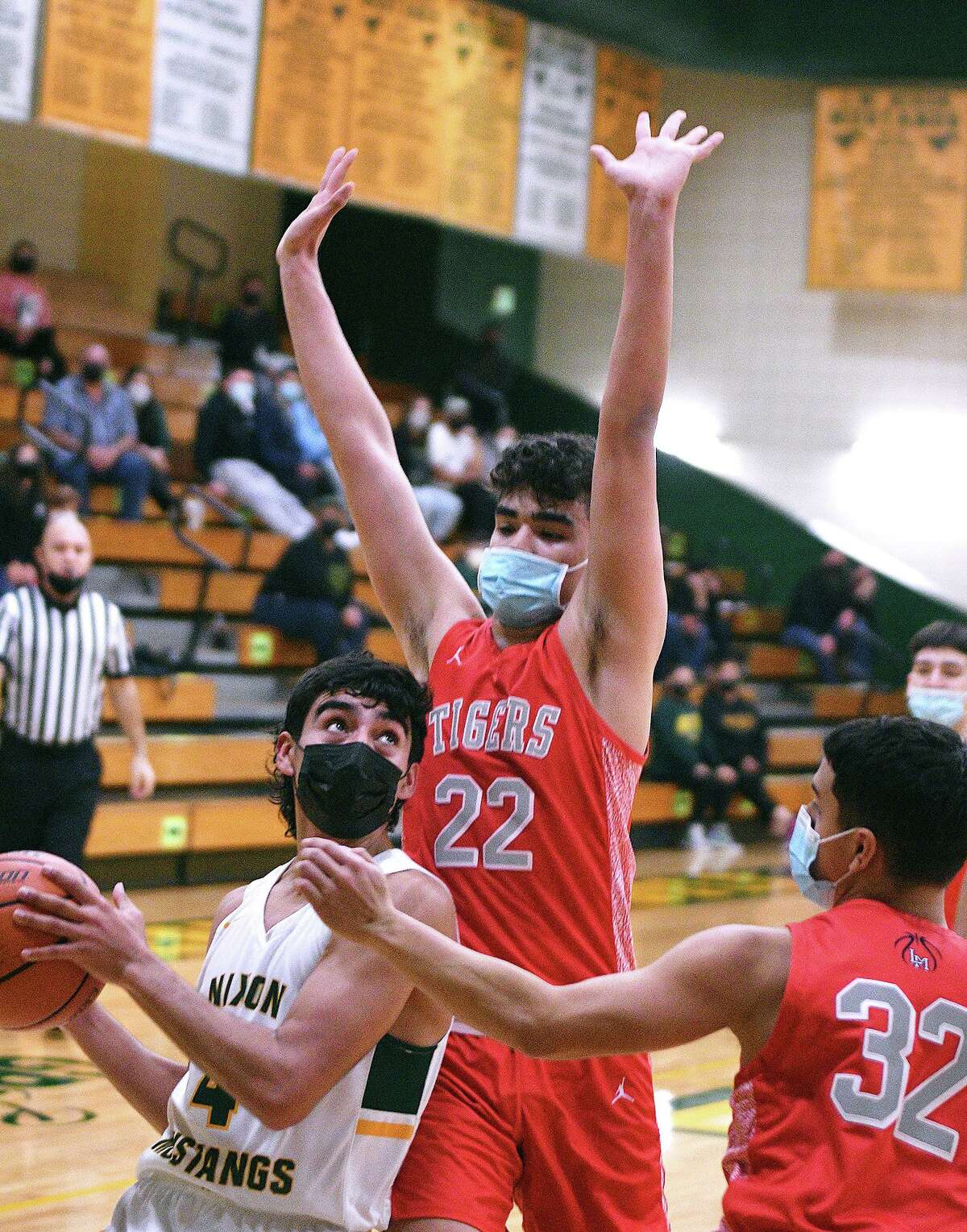 Juan Marines controls the ball for the Nixon Mustangs as Elijah Becker and Brandon Villarreal defend for the Martin Tigers Tuesday, December 15, 2020 at Nixon. Becker returned from COVID-19 protocols Tuesday.