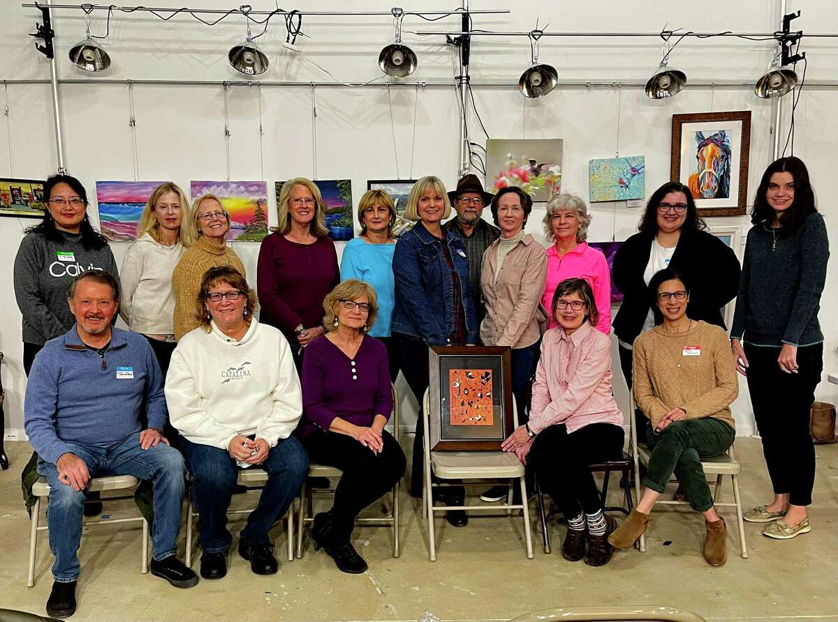 Woodlands Art League members and friends admire the recent donation of a Joan Miro painting by an anonymous art patron while attending WAL’s January general meeting.