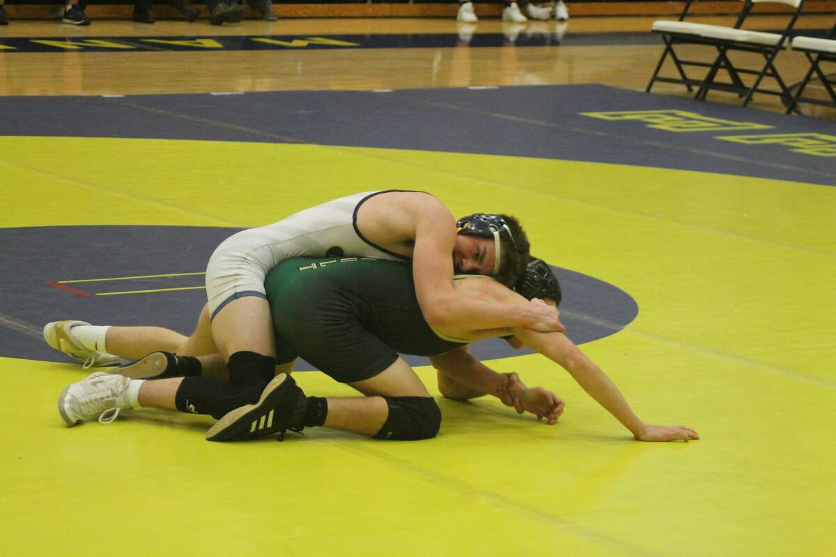 Manistee senior Ayden Bladzik-Garber takes on a Muskegon Catholic Central grappler in the 135-pound class Wednesday.