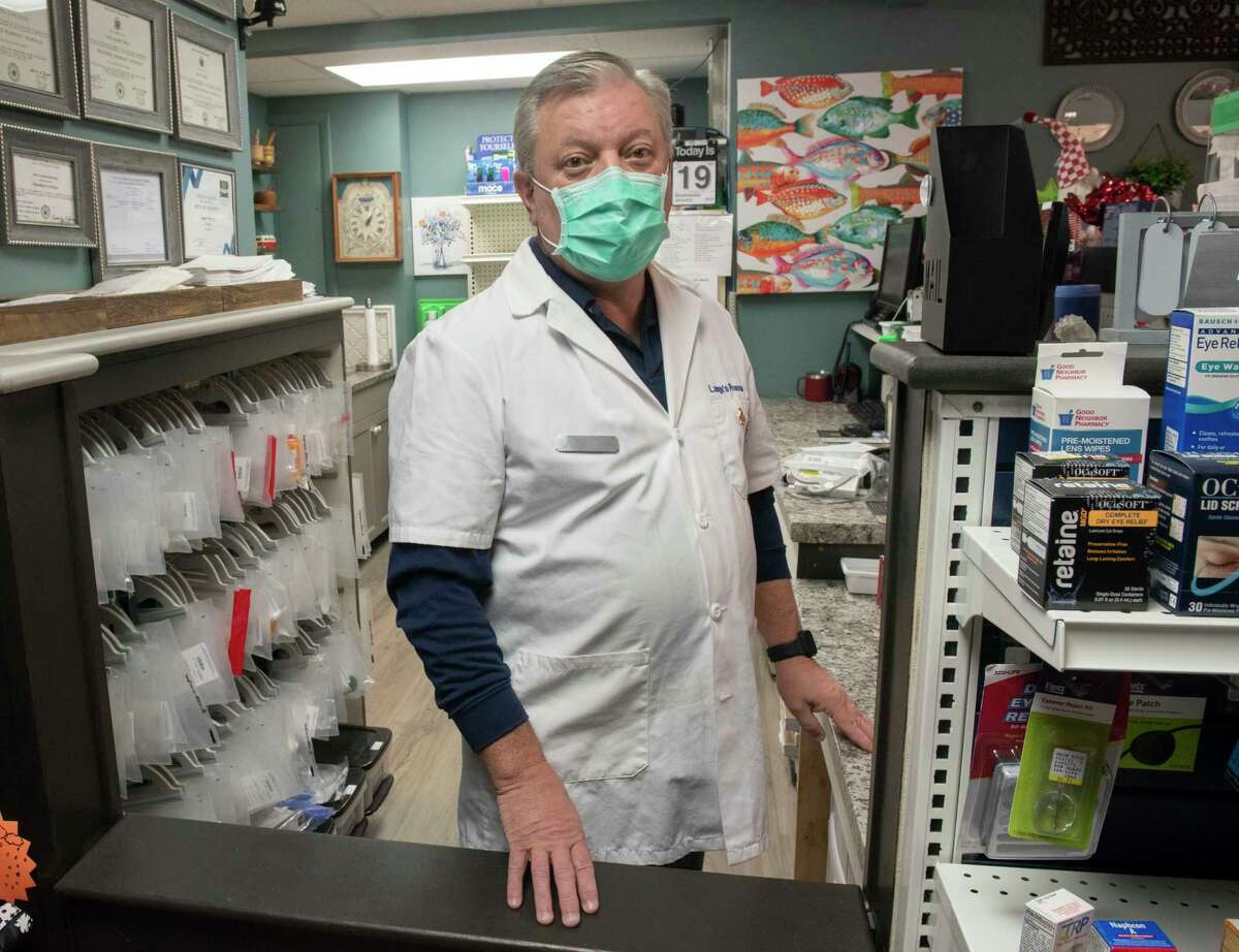 Dan Lange is seen behind the counter in Lange's Pharmacy on Wednesday, Jan. 19, 2022 in Schenectady, N.Y. The Pharmacy did not have any home COVID-19 test at this time.