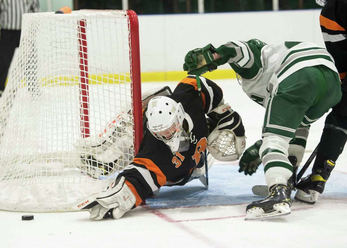 Bethlehem goalie Rorie Cairns attempts to cover the puck as Shen forward Keegan Linn pressures during a game on Wednesday, Jan. 19, 2022, in Clifton Park, N.Y. (Jenn March, Special to the Times Union)
