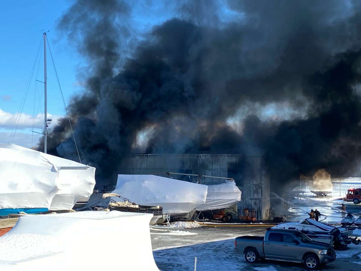 Thick smoke rises from the Coeymans Landing Marina where local firefighers are battling a fire that began late Thursday morning.