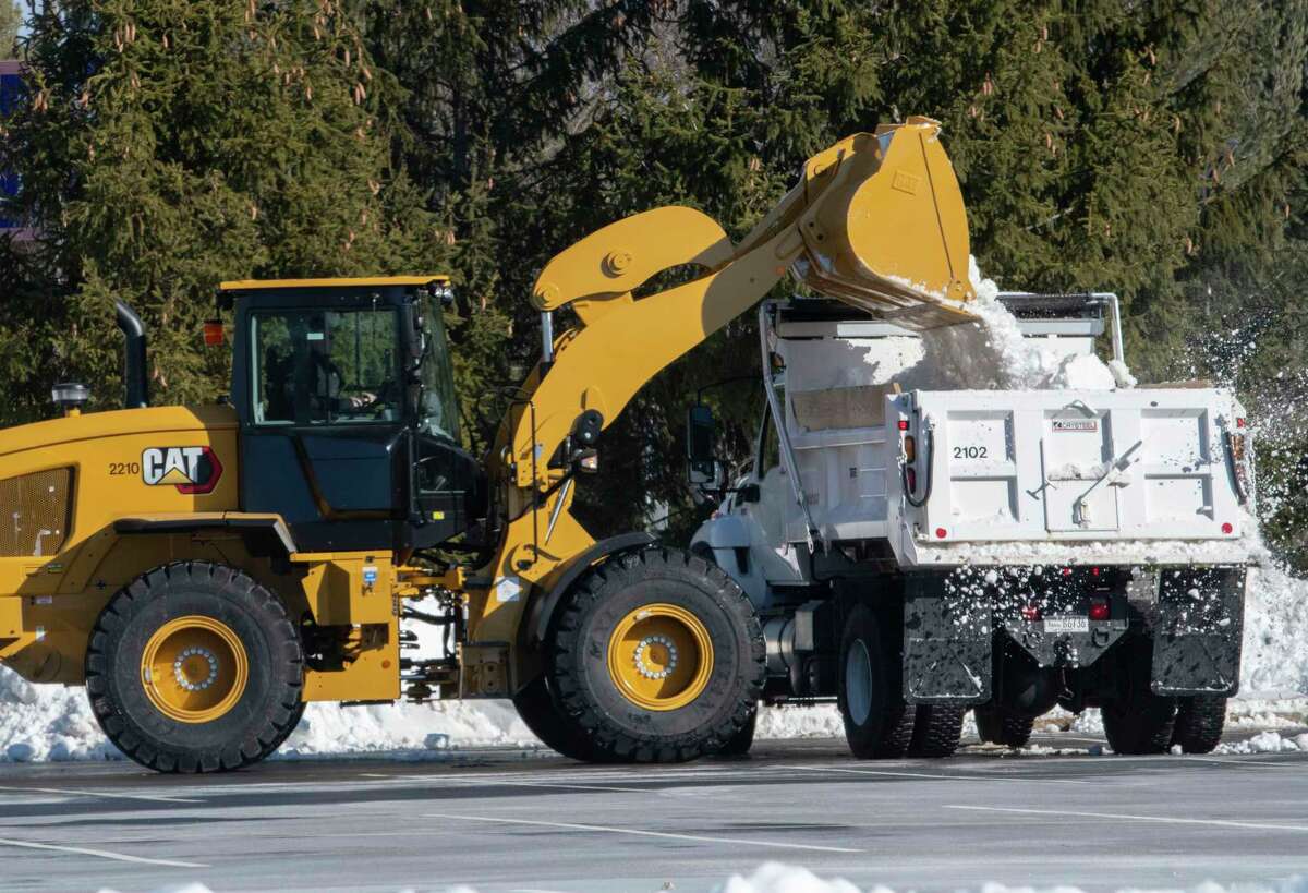 Highway crews in the Capital Region might not have much work to do this weekend. The National Weather Service said a powerful coastal storm is not expected to deal a major blow to the Albany area, Adirondack Mountains of Hudson Valley. In this photograph, crews work on removing large snowbanks on the edges of parking lots at University at Albany on Jan. 20, 2022 in Albany, N.Y.