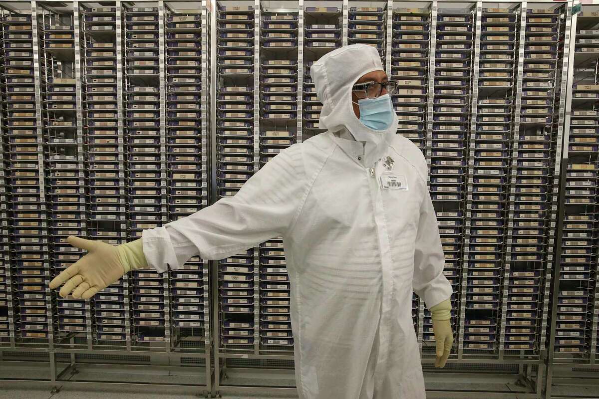 Manufacturing Section Manager Rohn Rao stands by a wall of master pattern in the Marfa Room at Tower Semiconductors in Westover Hills, Friday, Jan. 14, 2022. The company produces computer chips that are used in several industries including the automotive and smart phone production.