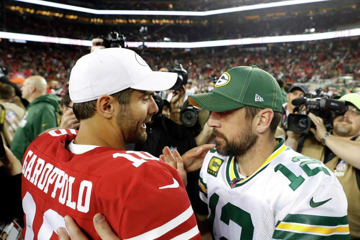 Quarterbacks Jimmy Garoppolo of the 49ers and Aaron Rodgers of the Packers meet after a 2019 game at Levi's Stadium in Santa Clara. The teams will meet in Green Bay, Wis., on Saturday in an NFC playoff matchup.