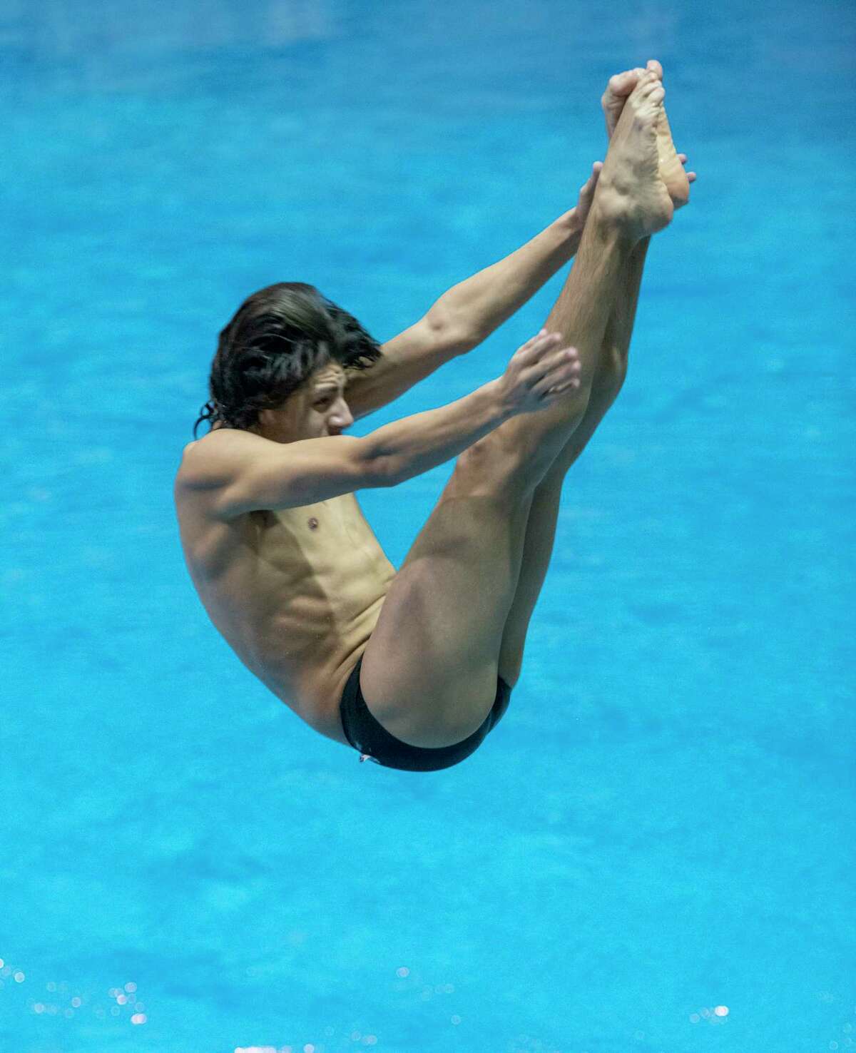 Midland High's Nick Stone performs a dive 01/20/2022 during the District 2-6A Championship at COM Aquatic Center. Tim Fischer/Reporter-Telegram