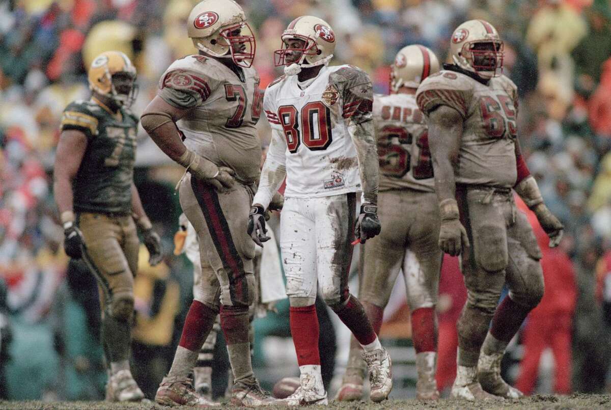 Jerry Rice (80) and the 49ers lost a divisional playoff game to the Packers 35-14 on a muddy Lambeau Field in January 1997. It was George Seifert’s last game as San Francisco’s head coach.