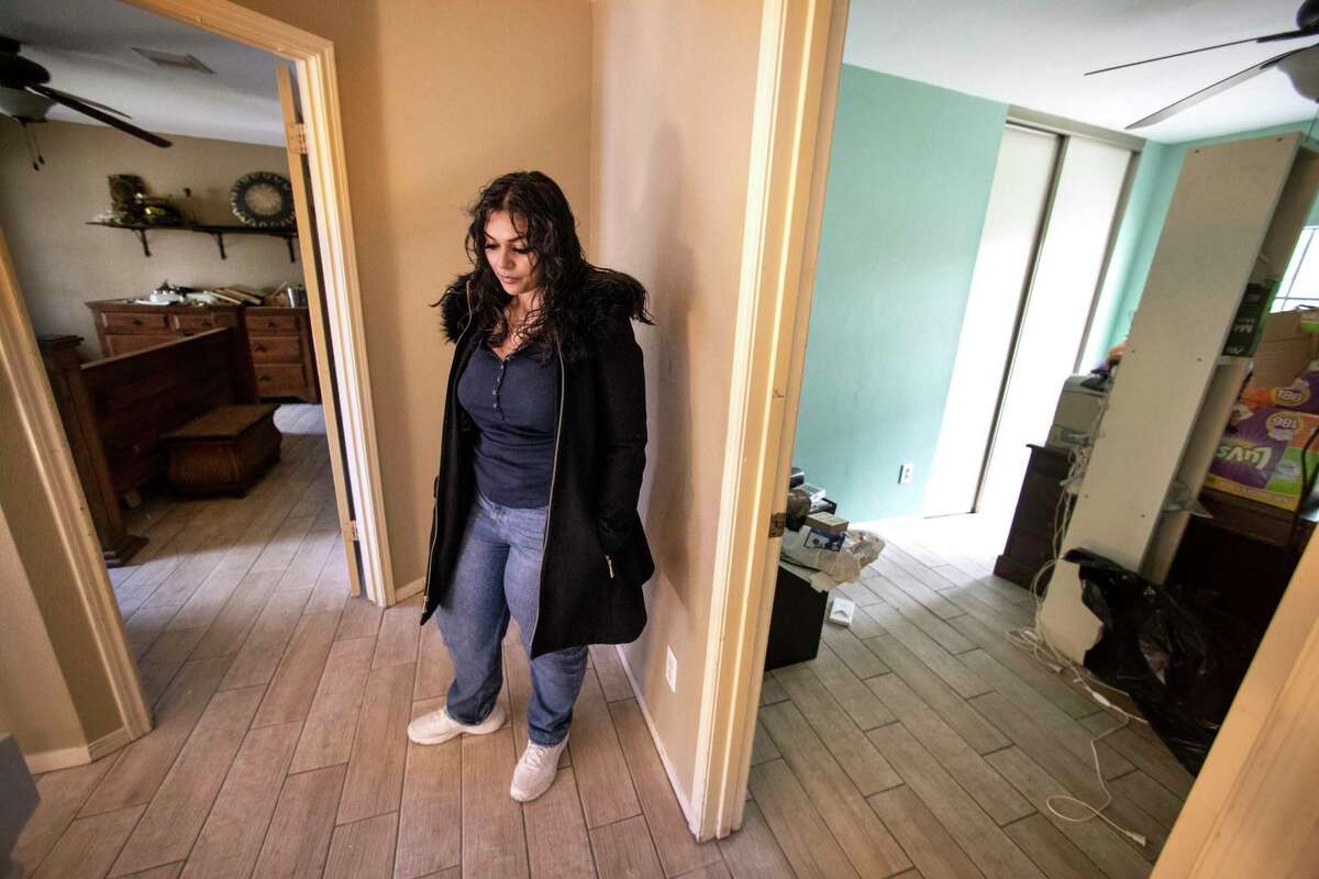 Mariam Ahmed stands next to her upstairs bedrooms as she checks on the progress of the restoration of her water damaged home on Thursday, Jan. 20, 2022 in Houston. Ahmed's home was severely damaged during last year's freeze, as a broken pipe poured water throughout the house. Renovations are nearly complete and she's scheduled to move back in on Monday.