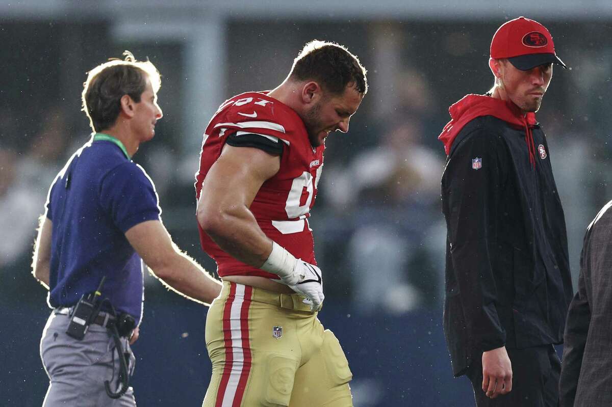 ARLINGTON, TEXAS - JANUARY 16: Nick Bosa #97 of the San Francisco 49ers walks off the field after an injury against the Dallas Cowboys during the second quarter in the NFC Wild Card Playoff game at AT&T Stadium on January 16, 2022 in Arlington, Texas. (Photo by Tom Pennington/Getty Images)