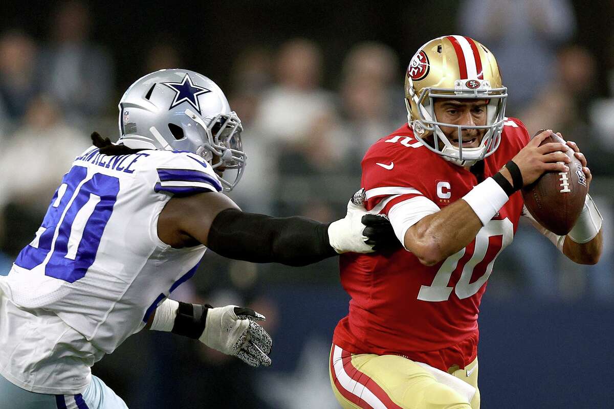 Dallas’ Demarcus Lawrence pressures 49ers QB Jimmy Garoppolo during the first half of Sunday’s playoff game.