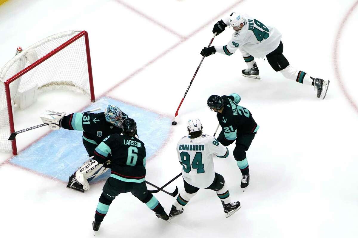San Jose Sharks' Tomas Hertl (48) scores against goaltender Philipp Grubauer (31) in the first period of an NHL hockey game Thursday, Jan. 20, 2022, in Seattle. (AP Photo/Elaine Thompson)
