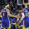 Klay Thompson (11) high fives Jonathan Kuminga (00) after an assist in the first half as the Golden State Warriors played the Indiana Pacers at Chase Center in San Francisco, Calif., on Thursday, January 20, 2022.