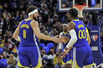 Klay Thompson (11) high fives Jonathan Kuminga (00) after an assist in the first half as the Golden State Warriors played the Indiana Pacers at Chase Center in San Francisco, Calif., on Thursday, January 20, 2022.