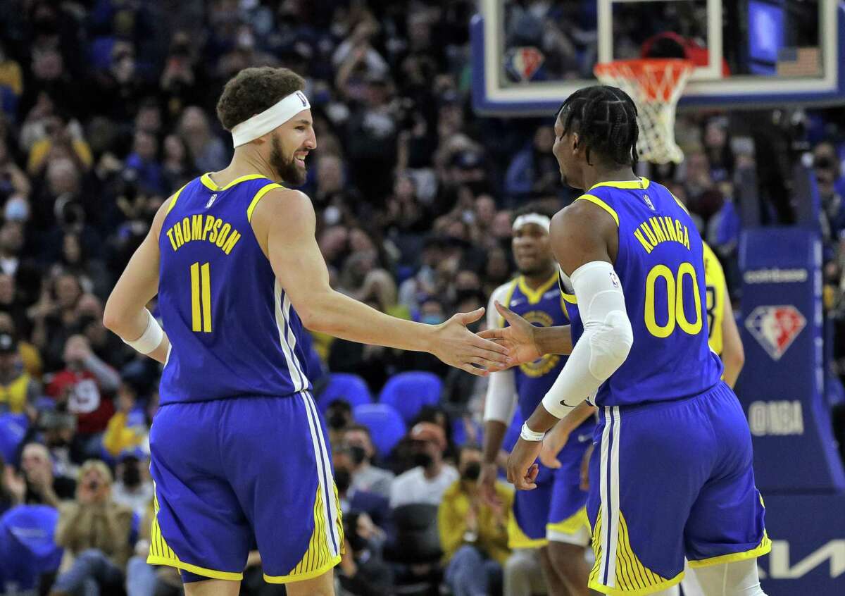 Klay Thompson (11) high fives Jonathan Kuminga (00) after an assist in the first half as the Golden State Warriors played the Indiana Pacers at Chase Center in San Francisco, Calif., on Thursday, January 20, 2022.