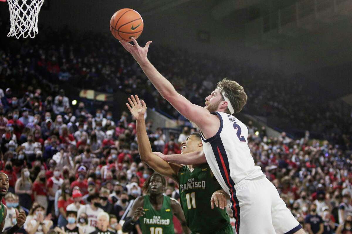 Gonzaga forward Drew Timme (2) shoots over San Francisco forward Patrick Tapé (11) during the first half of an NCAA college basketball game, Thursday, Jan. 20, 2022, in Spokane, Wash. (AP Photo/Young Kwak)