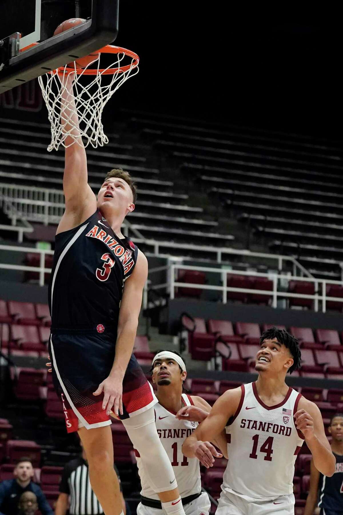 Arizona guard Pelle Larsson (3) shoots over Stanford forward Jaiden Delaire (11) and forward Spencer Jones (14) during the second half of an NCAA college basketball game in Stanford, Calif., Thursday, Jan. 20, 2022. (AP Photo/Jeff Chiu)