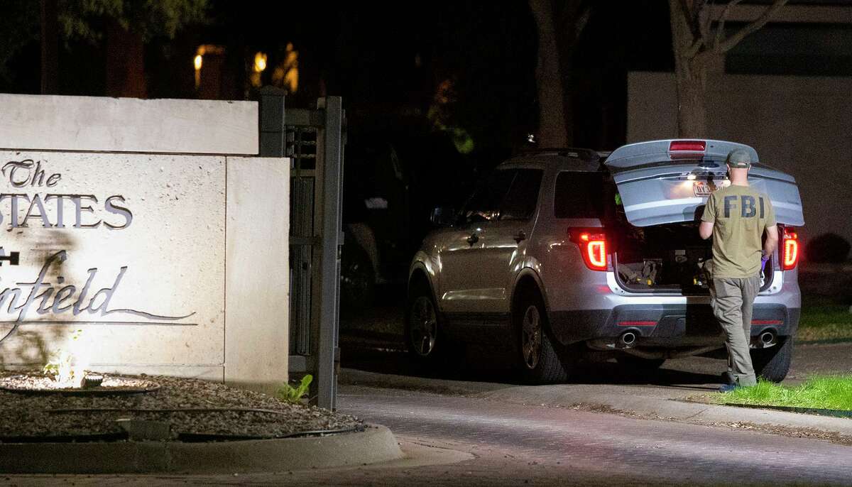 FBI agents are seen at the home of Rep. Henry Cuellar, Wednesday, Jan. 19, 2022.