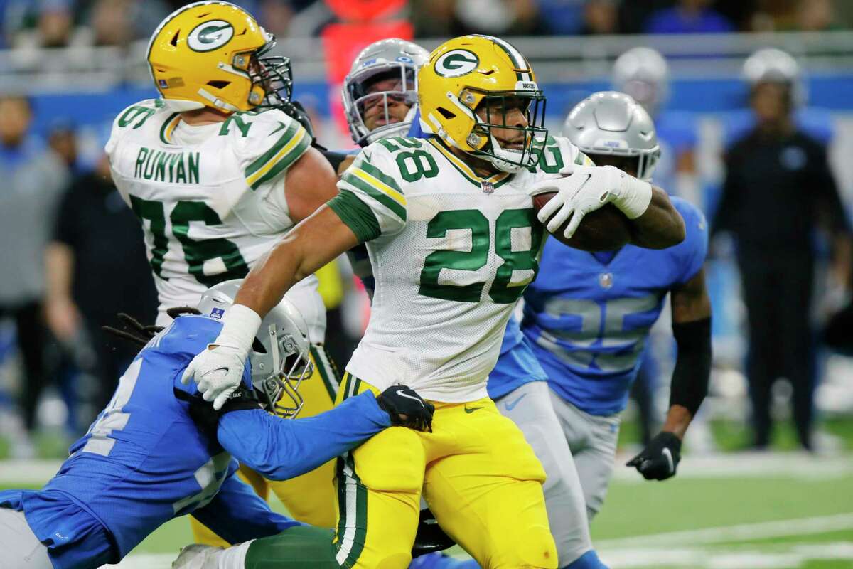 Green Bay Packers running back A.J. Dillon (28) rushes during the second half of an NFL football game against the Detroit Lions, Sunday, Jan. 9, 2022, in Detroit.