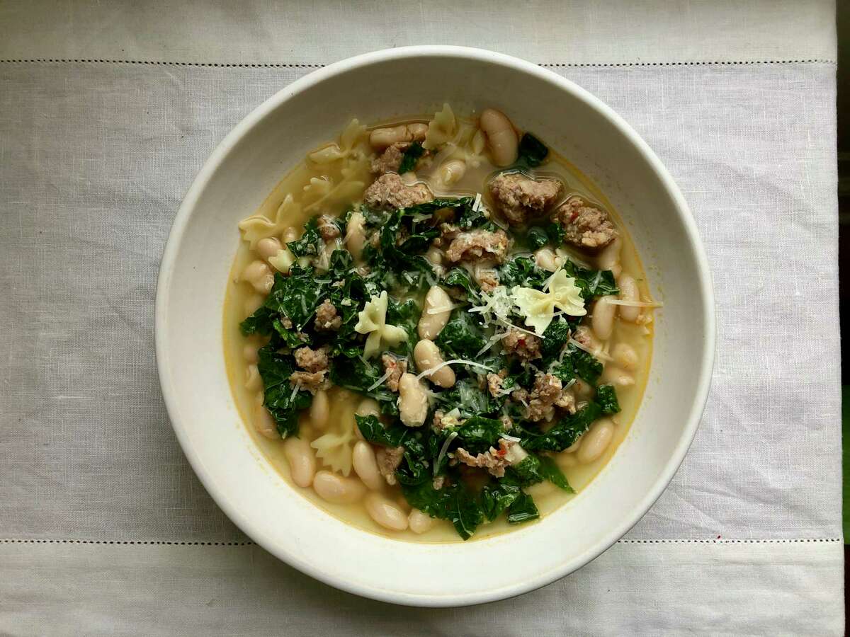 This pasta dish, full of beans, greens and sausage, is made it one pot.