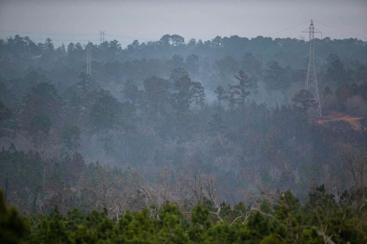 Despite winds in the 20 mph range, smoke continues to linger Thursday in the area of the Rolling Pines Fire in Bastrop County.