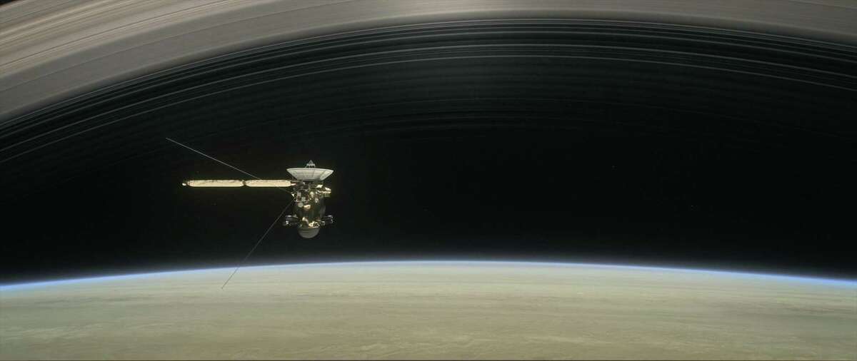 This illustration shows NASA's Cassini spacecraft about to make one of its dives between Saturn and its innermost rings as part of the mission's Grand Finale. Cassini made 22 orbits that swooped between the rings and the planet before ending its mission on Sept. 15, 2017, with a final plunge into Saturn.
