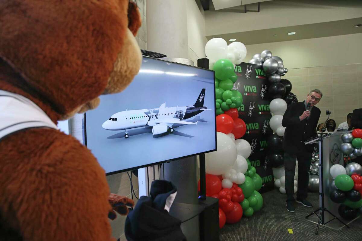 Spurs Sports and Entertainment CEO R.C. Buford and the Spurs Coyote unveil a Spurs-branded Airbus A320 plane.
