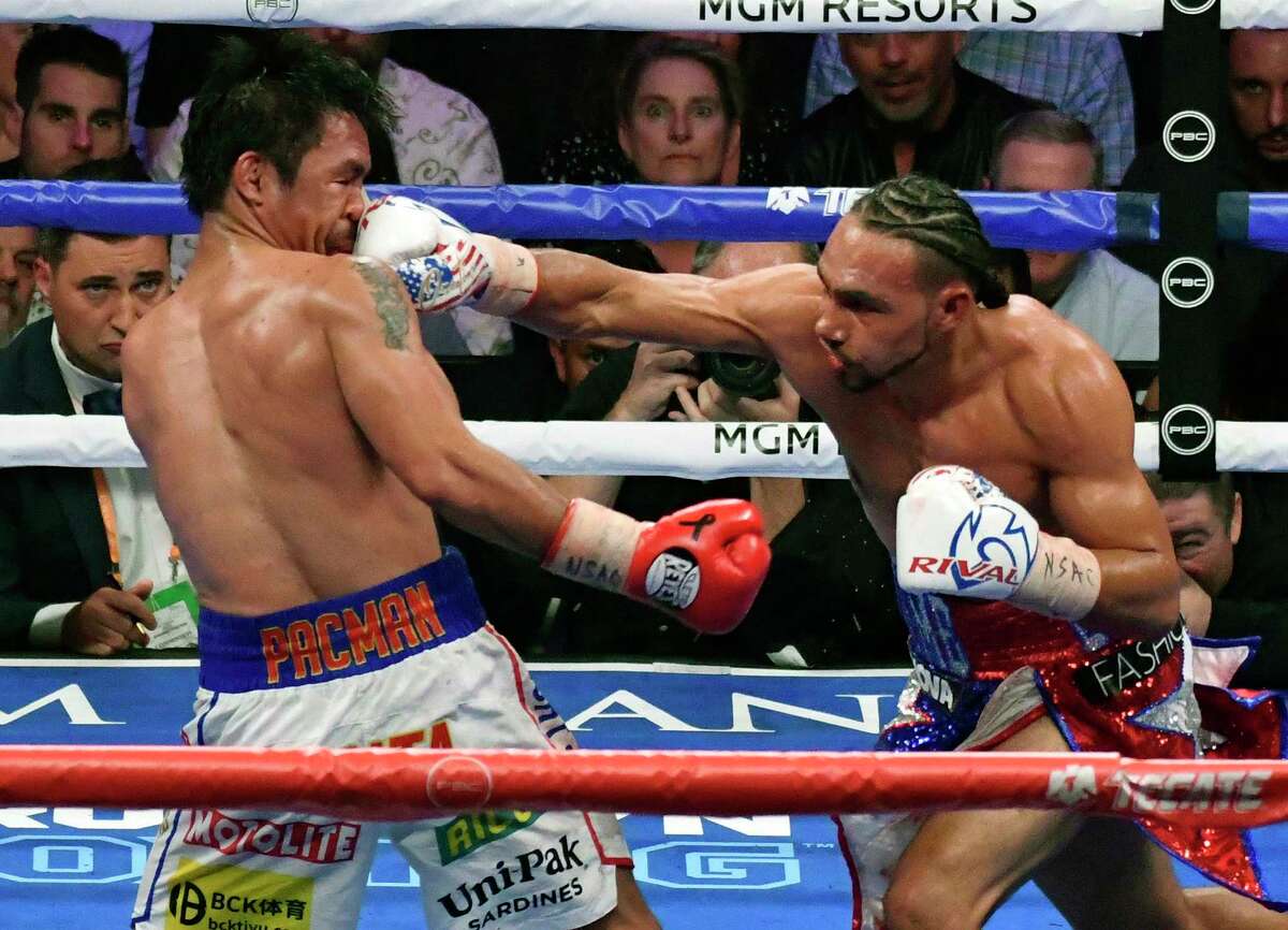 LAS VEGAS, NEVADA - JULY 20. Manny Pacquiao (L) takes a hit by Keith Thurman during their fight for the WBA welterweight title fight at MGM Grand Garden Arena on July 20, 2019 in Las Vegas, Nevada. Pacquiao went 12 rounds and took the win by a split decision.