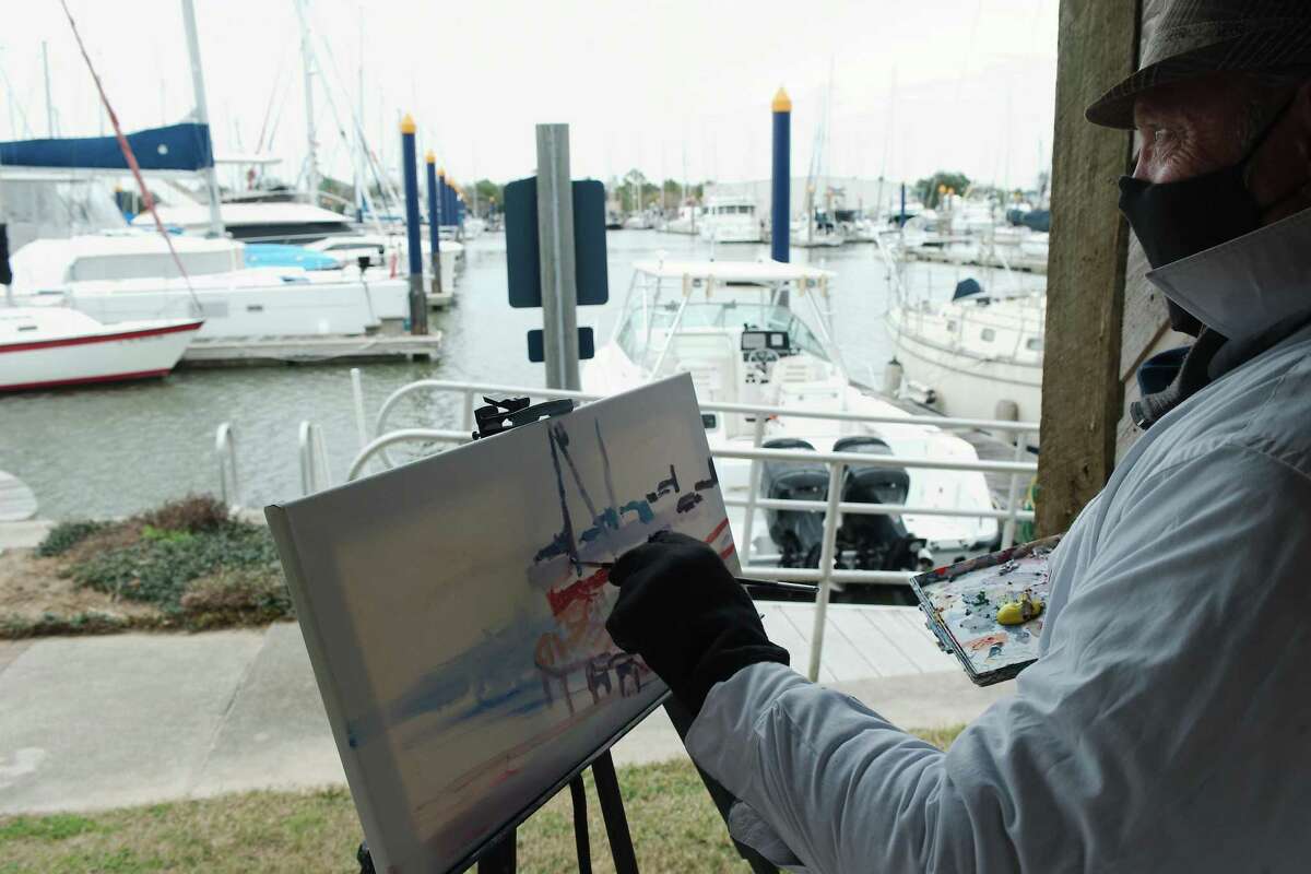 Arthur Deatly is inspired by the colors and shapes of the boats docked Watergate Yachting Center as he braves a chilly Friday morning to participate in “Plein Air Paint Out.”