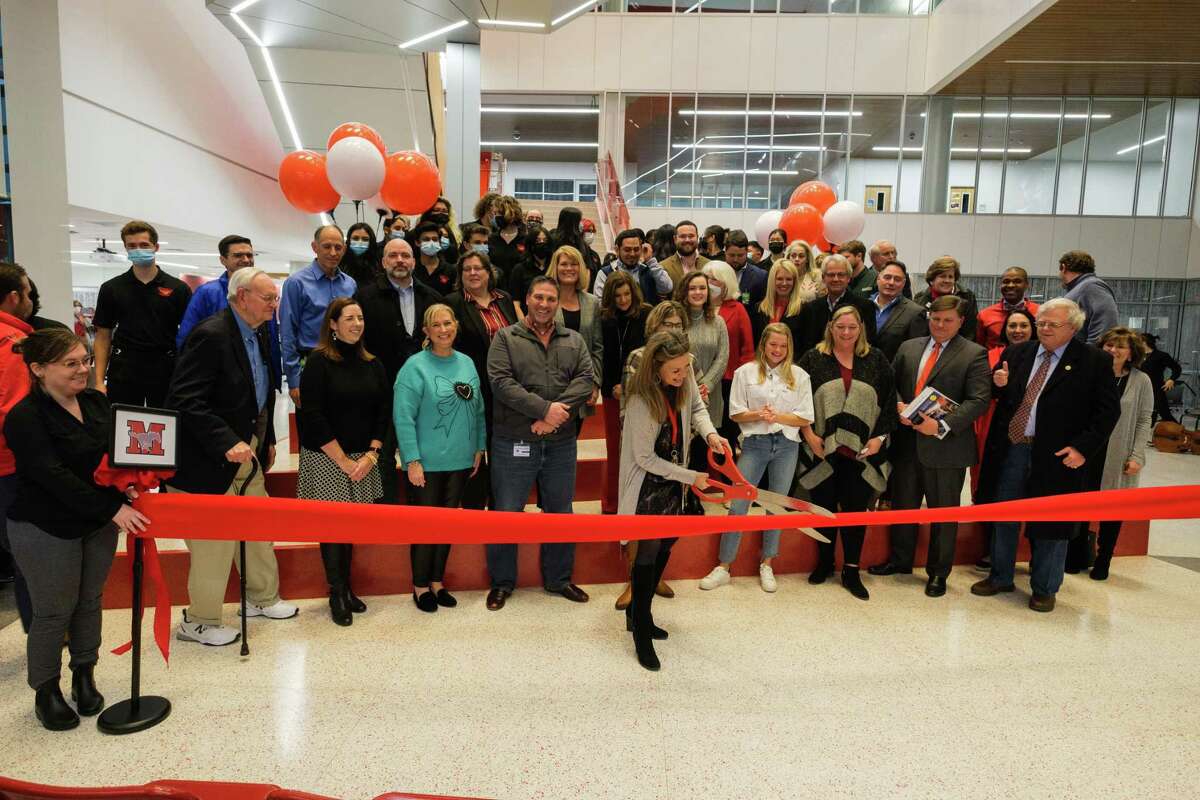 Memorial High School principal Lisa Weir, surrounded by members of the Memorial and Spring Branch ISD community, cuts the ceremonial ribbon during the grand opening ceremony for the new Memorial High School building on the afternoon of Jan. 20.