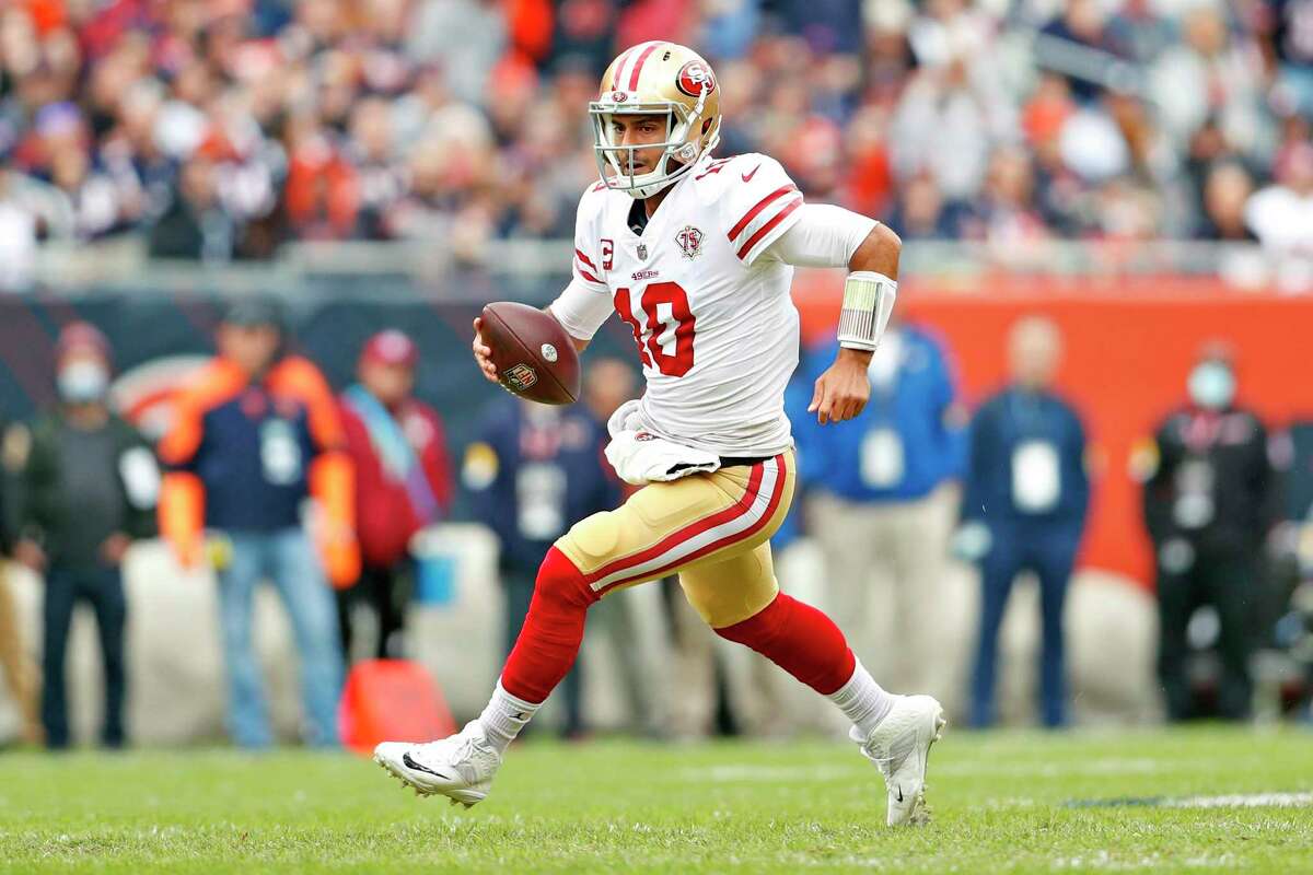 49ers quarterback Jimmy Garoppolo scrambles during San Francisco's 33-22 win over the Chicago Bears at Soldier Field in Chicago on Sunday, October 31, 2021.