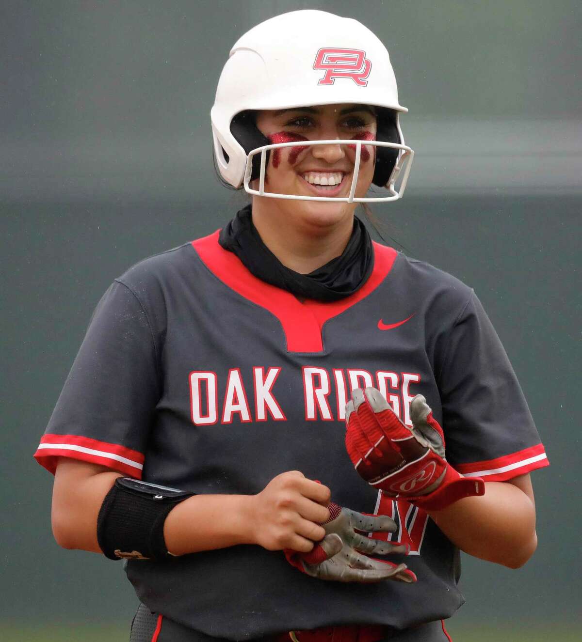Isabella Mazur (10) of Oak Ridge smiles after hitting a single during the fifth inning of a District 13-6A high school softball game at Willis High School, Friday, April 16, 2021, in Willis.