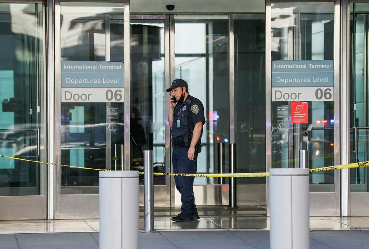 A police officer guards the door at the International Terminal at San Francisco International Airport (SFO) after police shot and killed a man they believed to have been armed. The man possessed two airsoft guns, which are not considered deadly weapons under state law.