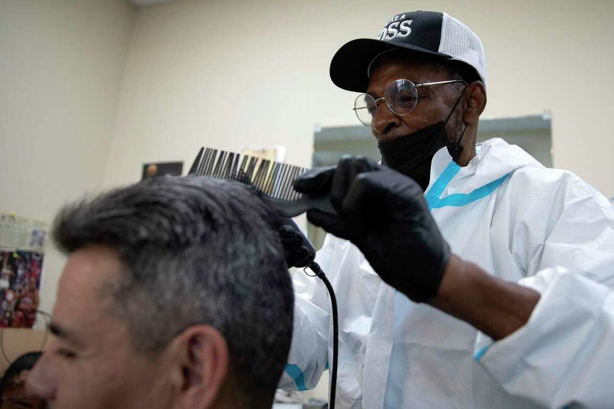 James Brown, 69, cuts Ernest Cevantes’ hair at the Haven for Hope hair salon. Brown who is a retired barber, has been volunteering at the near West Side homeless shelter for years.