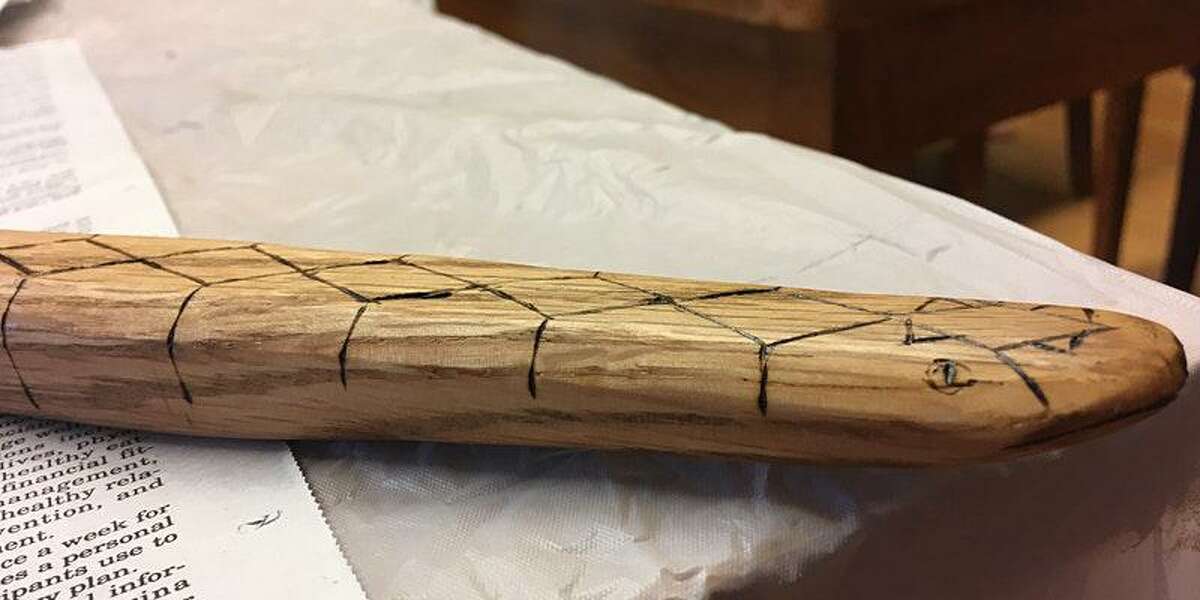The Institute for American Indian Studies in Washington, Connecticut, is having a snow snake workshop at 11 a.m., and at 2 p.m., on Saturday, Jan. 29, at the Institute. An example of a wood stick that has been used to make a snow snake with a pattern, and a notch on one of the ends of the stick, to make the stick, easier to throw when someone plays the winter game, is shown.