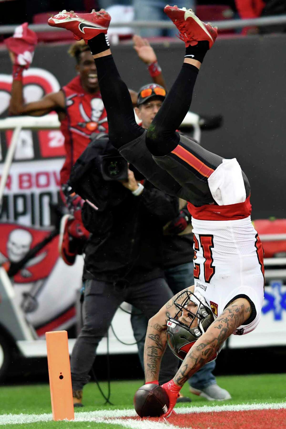 Tampa Bay Buccaneers wide receiver Mike Evans (13) celebrates after his touchdown reception against the Philadelphia Eagles during the second half of an NFL wild-card football game Sunday, Jan. 16, 2022, in Tampa, Fla. (AP Photo/Jason Behnken)