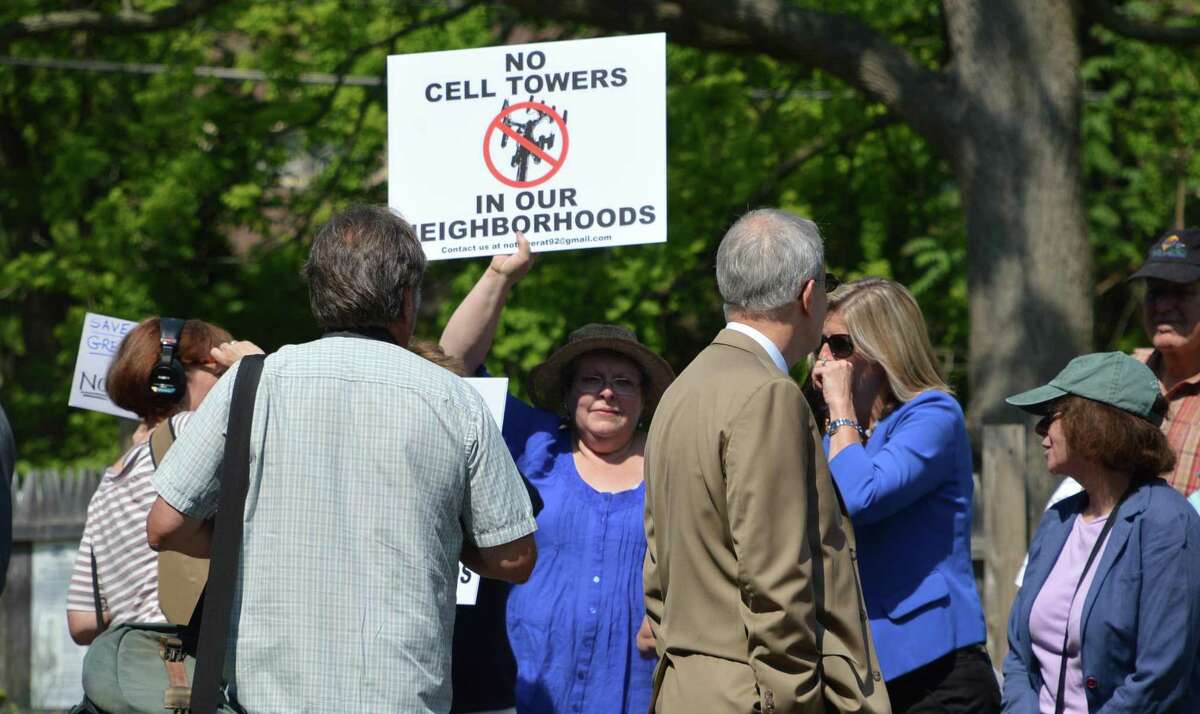 A protester waves a placard during a 2014 rally against a proposed cell tower on Greens Farms Road in Westport.