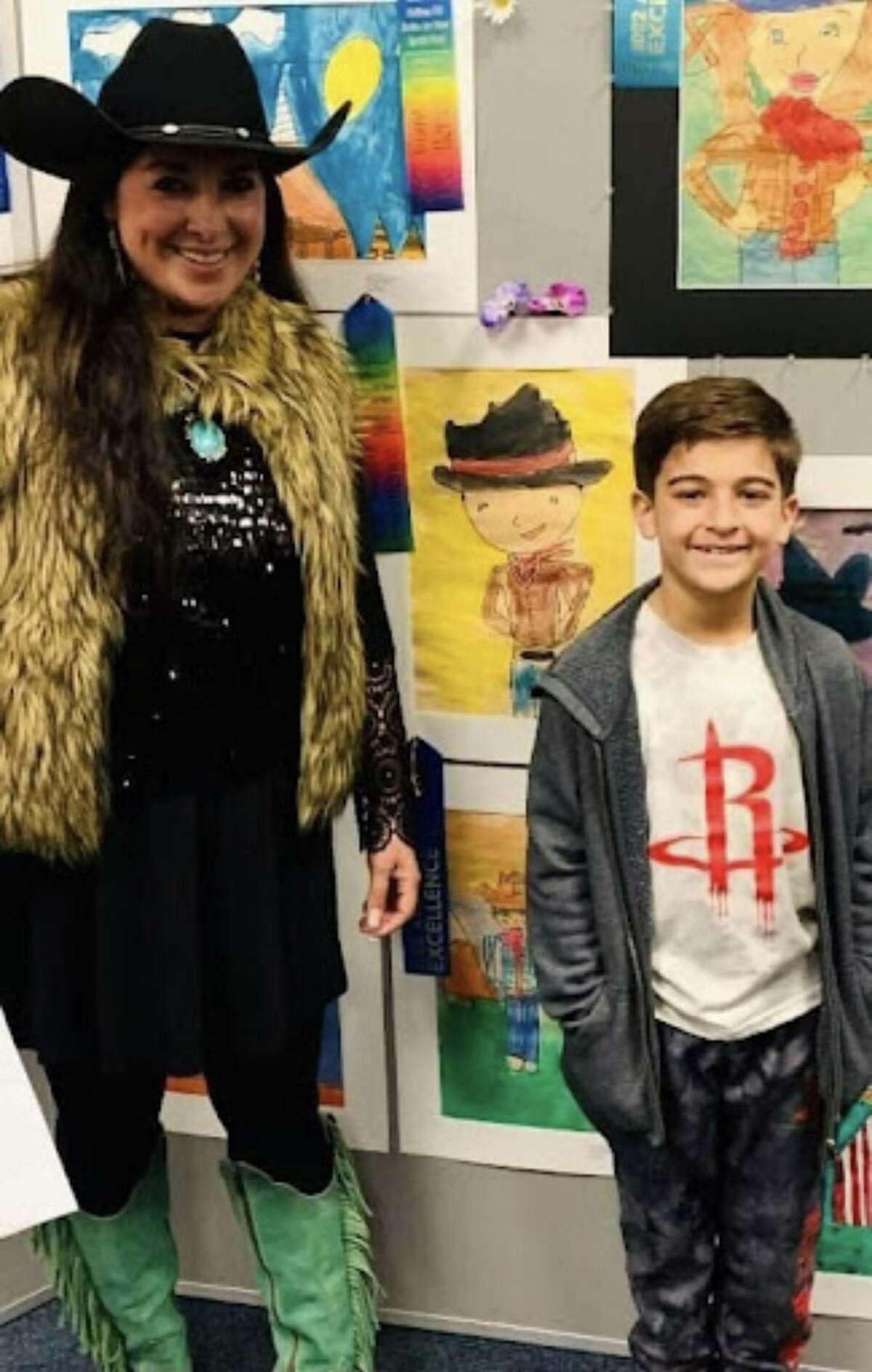 Huffman Art Liaison Victoria Parker with one of her art students. The winners will be taken to the Houston Livestock Show & Rodeo art competition next week. For those who missed the exhibit, works can also be viewed on the Huffman Visual Arts Facebook page.