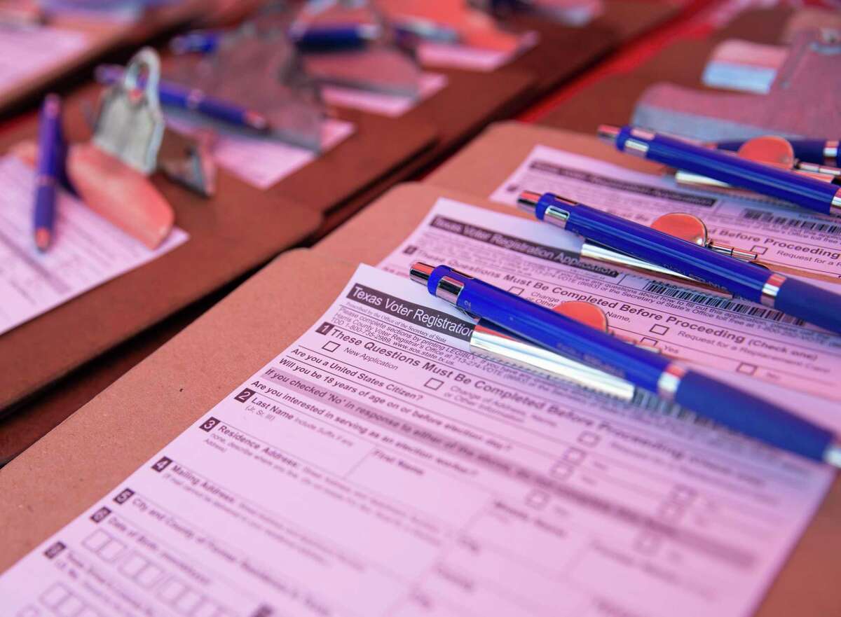 Texas voter registration application forms set out for people to register during a 2020 voter registration drive in Houston.