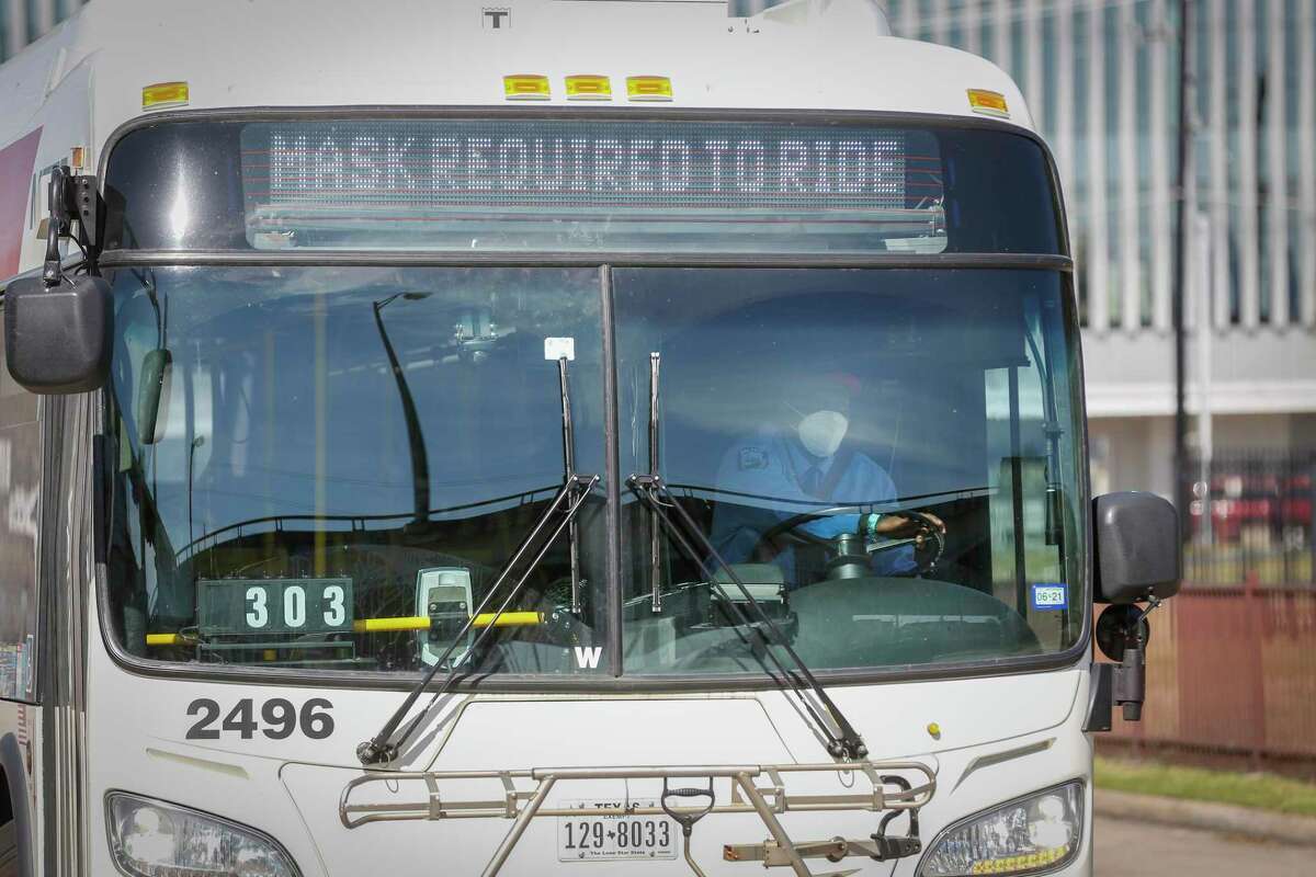 A mask requirement sign flashes on a Metropolitan Transit Authority bus at the Wheeler Transit Center on March 3, 2021, in Houston.