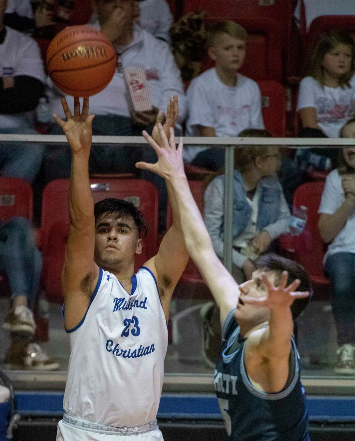 Midland Christian's Giovanni Lujan puts up a 3-point shot before Argyle Liberty's Kason Simpson can get over to defend 01/21/2022 at the McGraw Event Center. Tim Fischer/Reporter-Telegram