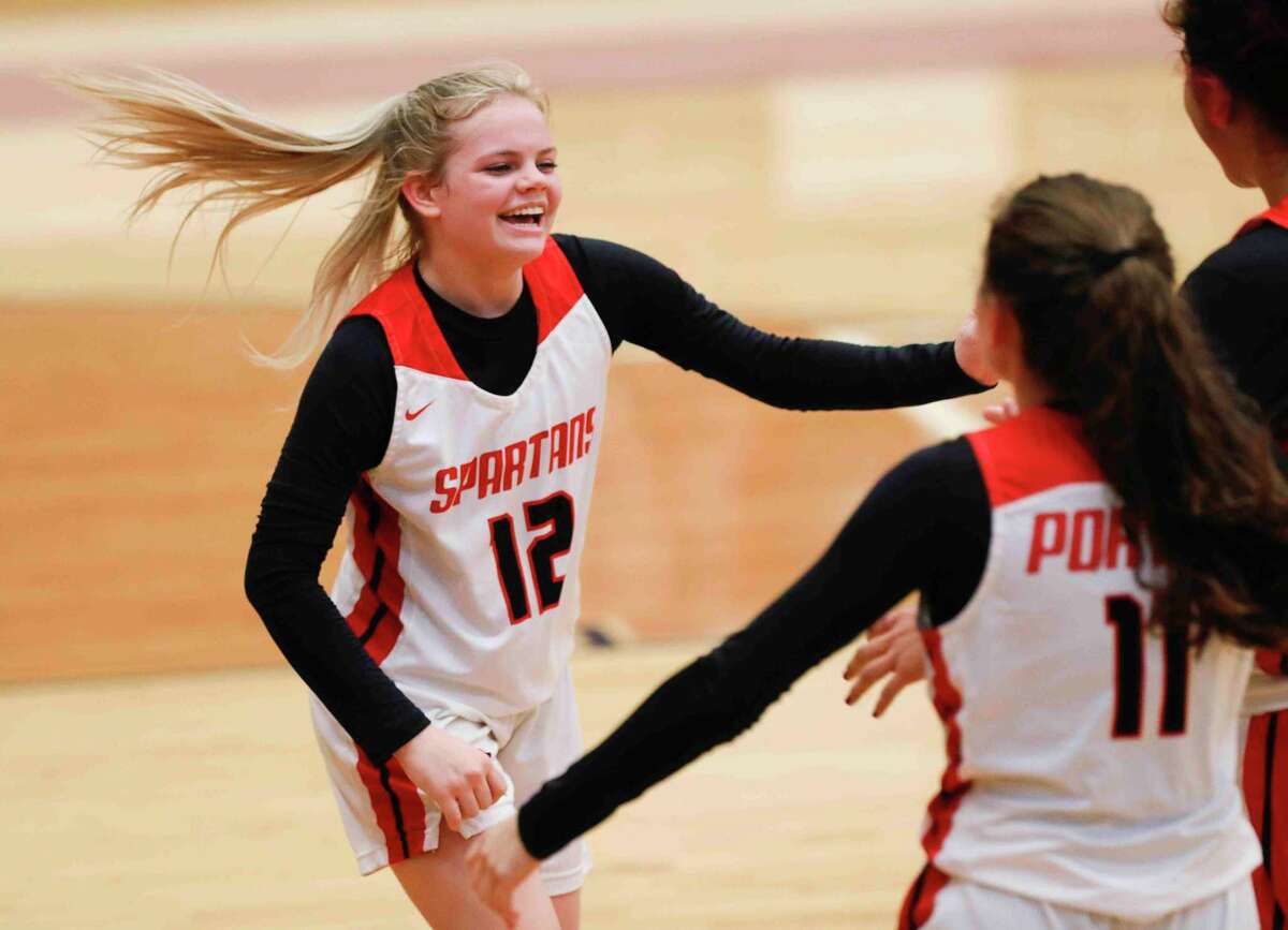 Porter point guard Allie Seybert (12) celebrates after making a layup at the buzzer to end the third quarter of a high school basketball game at Porter High School, Friday, Jan. 21, 2022, in Porter.