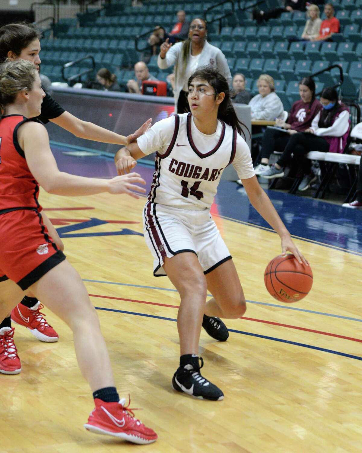 Madison Mascorro (14) of Cinco Ranch drives toward the basket during the second half of the third place game between the Cinco Ranch Cougars and the Katy Tigers in the Katy ISD Basketball Classic on Saturday, December 5, 2021 at the Leonard Merrill Center, Katy, TX.