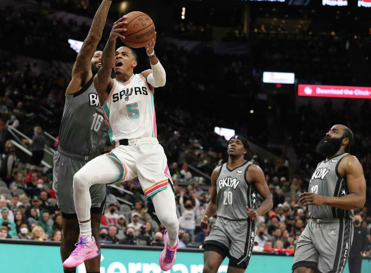 Spurs' Dejounte Murray (05) goes hard toward the basket against Brooklyn Nets' James Johnson (16) during their game at the AT&T Center on Friday, Jan. 21, 2022.