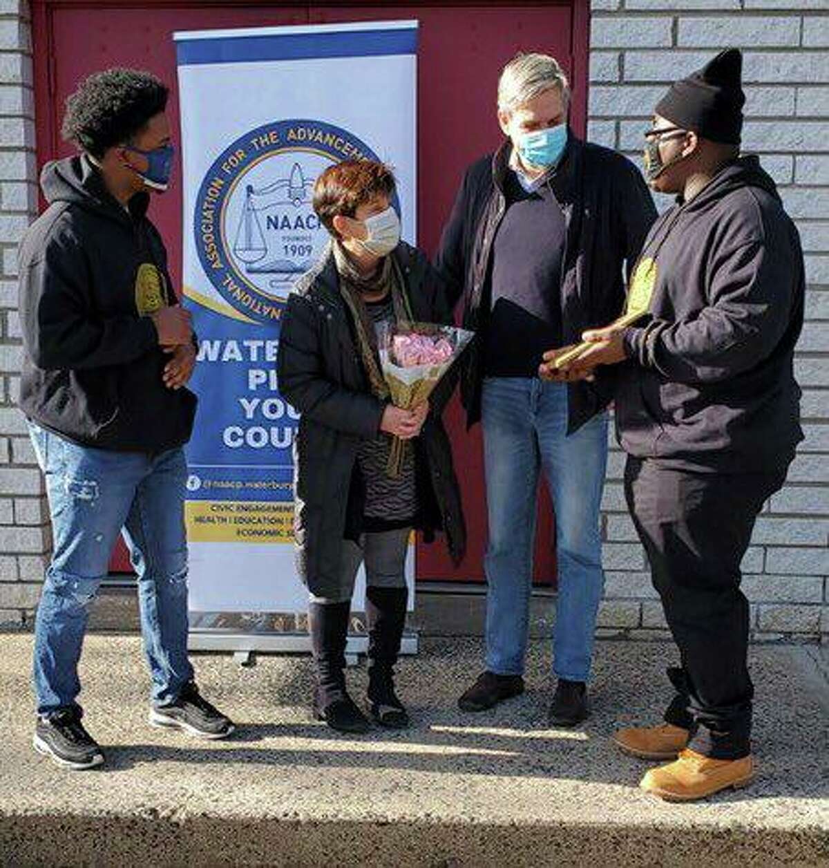 Amy and Bob Stefanowski, at center, received an award from the Waterbury NAACP Youth Corps on Sept. 9, 2021, for their volunteer work buying and distributing masks in the spring of 2020.