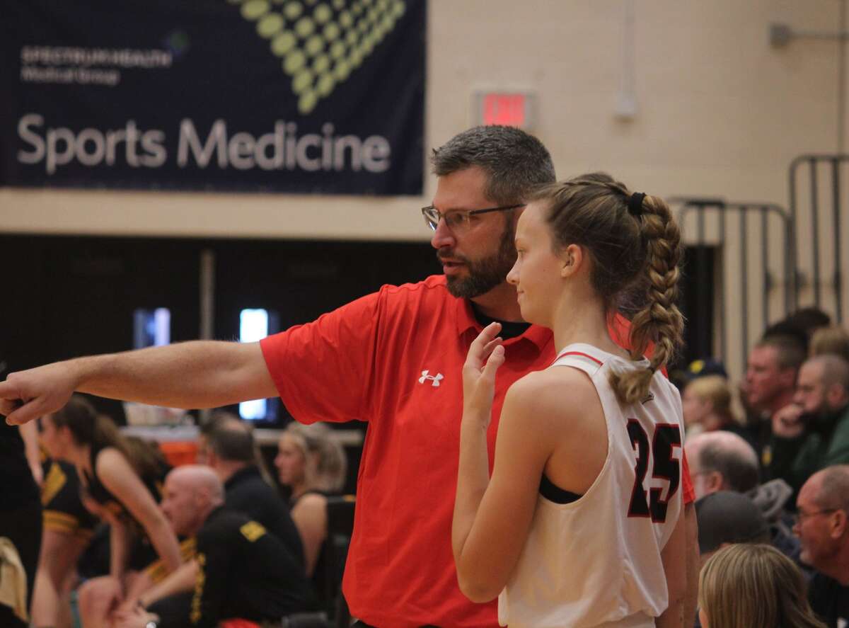 Tim Beilfuss (left) points out a play to Kyleigh Weck in action earlier this season.